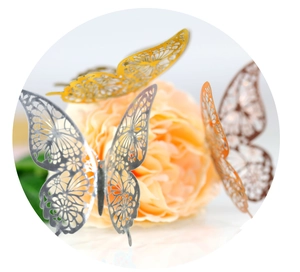 Macro detail of hollowed-out 3D butterfly wall stickers with metallic finish for home decor