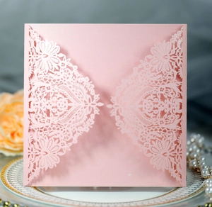 Detailed laser-cut pink lace wedding invitation on pearl paper with glitter finish