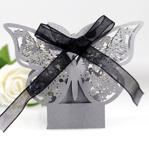 Macro detail of laser-cut hollow pattern and glitter texture on butterfly candy box
