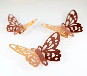 Three rose gold 3D hollow butterfly wall stickers with intricate laser-cut metal textures