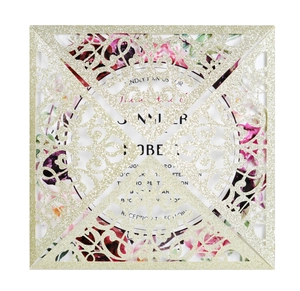 Detailed close-up of glitter gold laser-cut square wedding invitation with floral insert