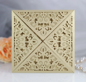 Detailed laser-cut champagne gold wedding invitation card with elegant floral patterns