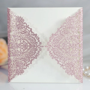 Detailed laser-cut lace floral pattern on pink glitter wedding invitation cardstock