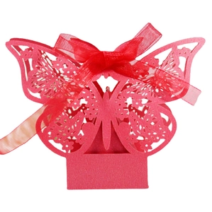 Red laser-cut butterfly favor box made of shimmering pearlescent paper with ribbon bow