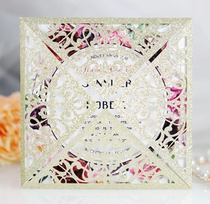 Detail of laser-cut gold glitter wedding invitation with elegant floral insert card