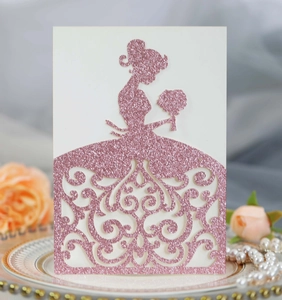 Detail of laser-cut glitter paper wedding invitation with elegant bride silhouette