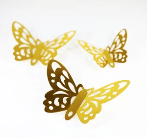 Detail view of golden hollow-out butterfly wall stickers with intricate laser-cut patterns
