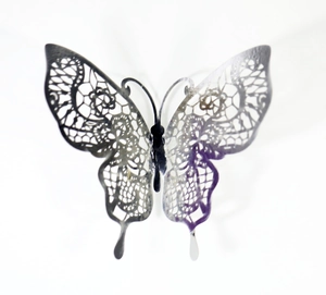 Macro detail of silver lace hollow butterfly wall sticker for elegant home decor