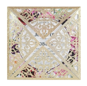 Detailed laser-cut gold glitter invitation with elegant lace patterns and floral insert