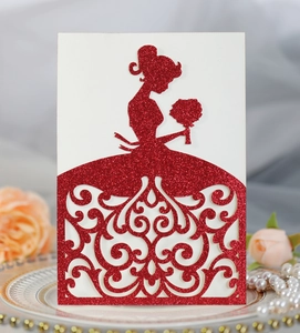Detail of red glitter laser-cut bride silhouette on elegant wedding invitation card
