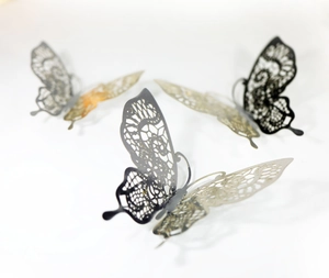 Detail of 3D hollow butterfly wall stickers with intricate laser-cut golden patterns
