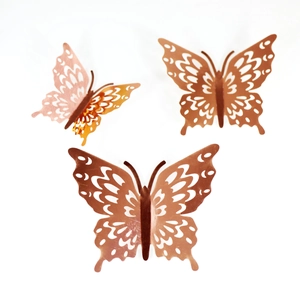 Detail of rose gold 3D laser-cut butterfly wall stickers with intricate hollow patterns