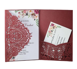 Detail of laser-cut burgundy floral wedding invitation set with floral inner card