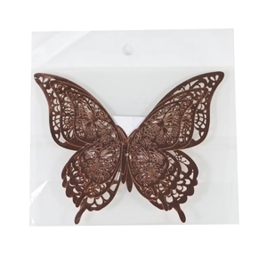 Macro detail of laser-cut 3D metallic butterfly wall stickers in copper finish with packaging