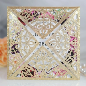 Detail showing laser-cut gold glitter invitation cover with elegant floral inner card