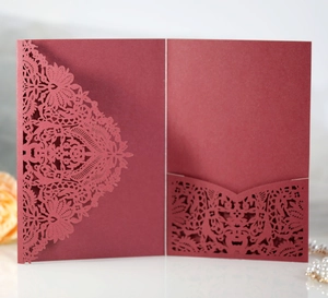 Detailed laser-cut burgundy invitation pocket with intricate mandala flower patterns
