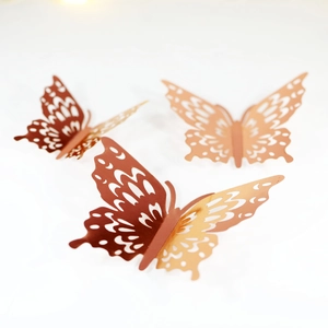 Close-up of 3D rose gold hollow butterfly wall stickers with intricate laser-cut textures