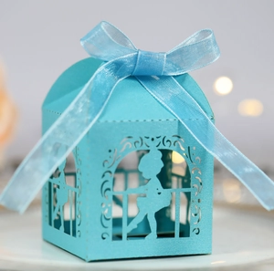 Macro shot of light blue laser-cut wedding candy box with a ballet dancer silhouette