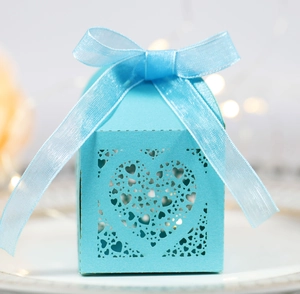 Close-up of laser-cut heart pattern on light blue favor box with ribbon detail