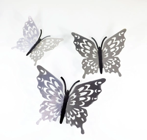 Detailed view of 3D laser-cut hollow butterfly wall stickers in three gradient grey tones