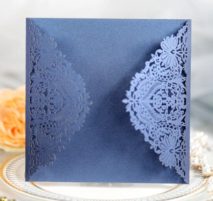 Detailed laser-cut lace pattern on deep blue pearlescent paper wedding invitation