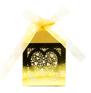 Golden laser-cut wedding favor box with heart pattern and yellow organza ribbon