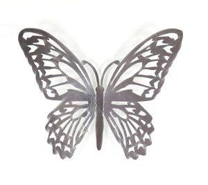 Macro detail of dark grey metallic 3D butterfly wall sticker with hollow geometric pattern