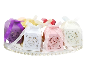 Laser-cut heart-shaped wedding candy boxes with satin ribbons in multiple colors
