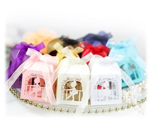 Laser cut dancing girl candy boxes in assorted colors with silk ribbon bows for weddings