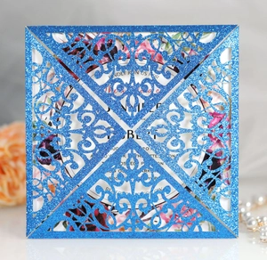 Detail of laser-cut navy blue glitter invitation with floral inner card and pearls