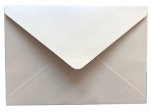 Detail of minimalist beige V-flap envelope with matte pearlescent paper texture