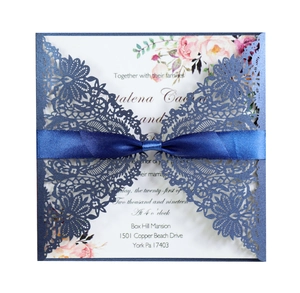 Navy laser cut wedding invitation with blue satin ribbon and floral insert card