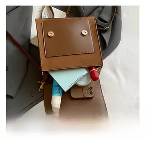 Interior view of vintage brown backpack showing space for phone and makeup items
