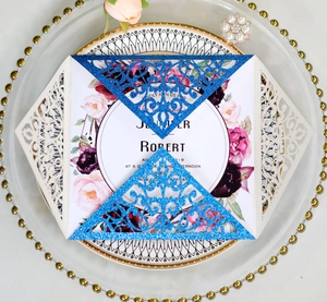 Detailed laser cut lace wedding invitation with glitter blue cover and floral inner card