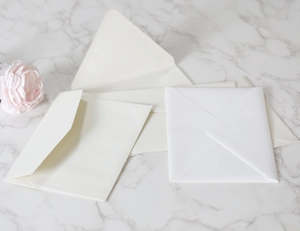 European pearlescent 150g thick paper envelopes for wedding invitations on marble surface
