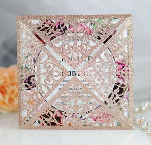 Detail of rose gold glitter laser-cut wedding invitation with floral insert card