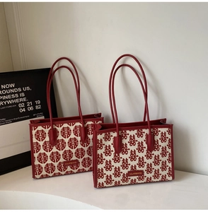 Close-up of red and beige canvas tote bags with traditional double happiness embroidery