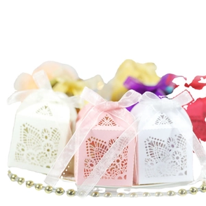 Elegant laser-cut hollow ivory wedding favor boxes with silk ribbon and lace patterns