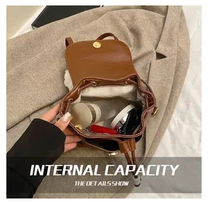 Detail view of the vintage brown leather backpack opening to show its spacious interior