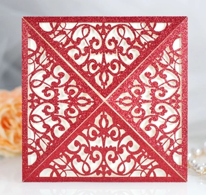 Detail of red glitter square laser cut wedding invitation with floral patterns