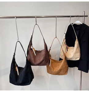 Suede-textured tote bags with wooden bead tassel in black, brown, tan, and beige
