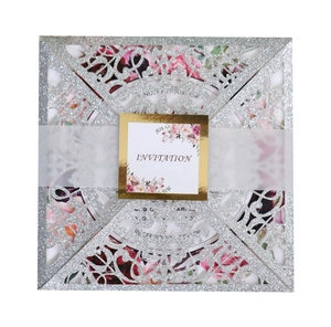 Silver glitter laser-cut wedding invitation with floral vellum belly band and card