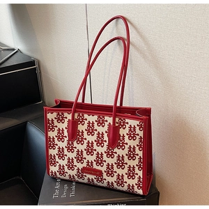 Detail of red wedding tote bag featuring festive double happiness jacquard and leather logo