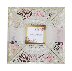 Square gold glitter laser cut wedding invitation featuring floral liner and lace sleeve