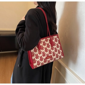 Detail of red wedding tote bag with traditional Double Happiness embroidery pattern