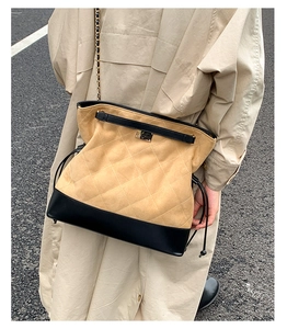 Street style shot of vintage quilted chain bag with suede khaki and black leather mix