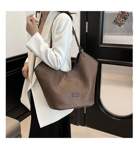 Close-up of the woven brown faux leather texture on this large stylish tote bag