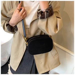 Detail of black frosted matte camera bag featuring premium gold hardware and zipper