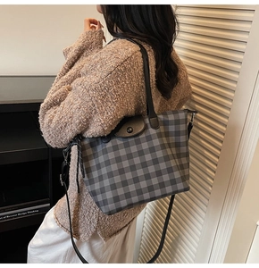 Detailed view of checkered tote bag worn as a shoulder bag in a lifestyle setting
