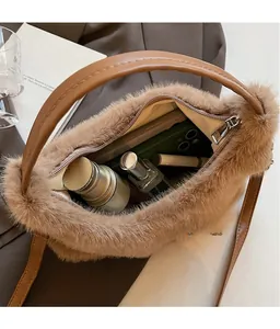 Vue détaillée du rangement intérieur du sac bandoulière marron en peluche avec cosmétiques